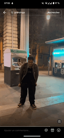 a man standing in front of an atm machine with the word grandingo on it