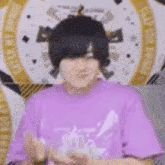 a man in a purple shirt is making a funny face