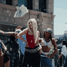 a woman in a red top is surrounded by bubbles and people