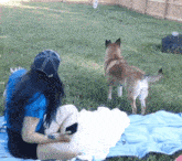 a woman sitting on a blanket looking at a dog with the word move on the bottom