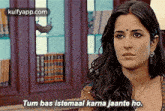 a close up of a woman 's face with the words `` tum bas istemaal karna jaante ho '' .