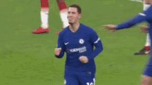 a blurry picture of a soccer player celebrating a goal with his teammates .