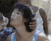 a gif of a woman getting her hair braided with the website gifbin.com visible in the corner