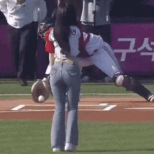 a baseball player with the number 21 on his jersey is being held by a woman