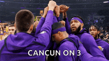 a group of basketball players are huddled together in a huddle with the words cancun on 3 written on the bottom .