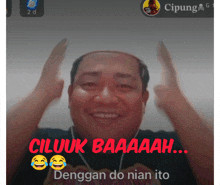 a man with a bald head is laughing with the words ciluk baaaaah behind him