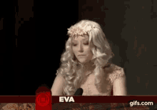 a woman in a wig is talking into a microphone .