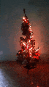 a christmas tree with red lights and a star