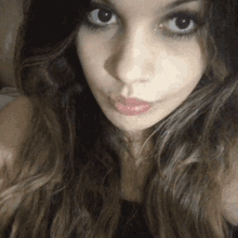 a close up of a woman 's face with a slight smile on her face