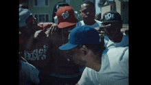 a group of men wearing hats including one that says tde on it