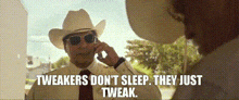 a man in a cowboy hat and tie talking on a cell phone with the words tweakers don 't sleep