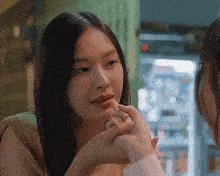 a woman is holding another woman 's hand and looking at her face