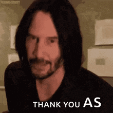 a man with long hair and a beard is giving a thumbs up and saying `` thank you as '' .