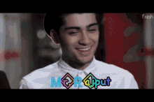 a man is smiling in front of a screen that says mor @put