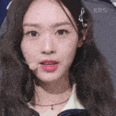 a close up of a woman 's face with the kbs logo visible