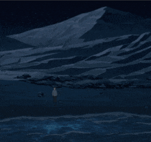 a man is standing in front of a mountain in the dark