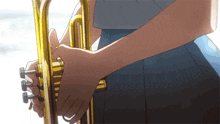 a person is holding a trumpet in their right hand