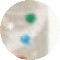 a blurred image of a circle with a green and blue square in the middle .