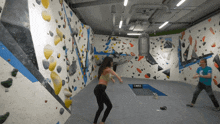 a man and a woman are playing in a room with a sign that says cube on it