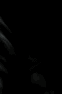 a black and white photo of a person in the dark
