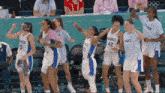 a group of female basketball players from france are dancing together