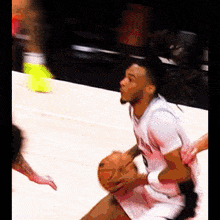 a basketball player with the number 9 on his jersey dribbles the ball