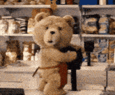 a teddy bear is holding a stuffed animal in front of a store shelf