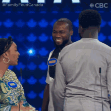 a man wearing a shirt that says marseen talks to a woman
