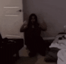 a woman is sitting in a chair in a dark room .