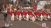 a parade with a banner that says happy new year on it