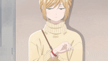 a girl in a yellow sweater with bows on it is looking down