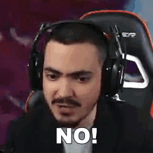 a man wearing headphones is making a funny face and says no .
