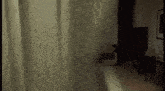 a dark room with a shower curtain hanging on the window