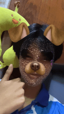 a person with a dog mask on their face is giving a thumbs up