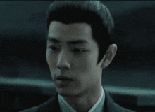a close up of a man 's face in a suit