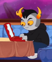a cartoon character is sitting at a table using a red laptop .