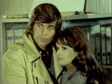 a man and a woman standing next to each other