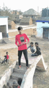 a boy wearing a red shirt that says ' reebok '