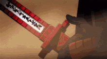 a person is holding a sword with chinese writing on it