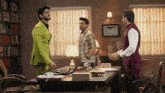 a man in a green suit is standing in a room with two other men