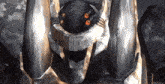 a close up of a robot 's head with red eyes