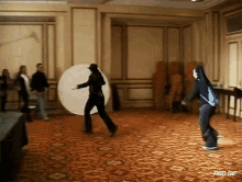 a group of people are playing a game in a room with the words rbd.gif on the bottom right