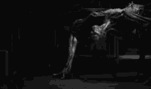a black and white photo of a monster in a dark room