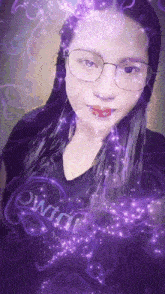 a woman wearing glasses and a black shirt that says ' witch ' on it