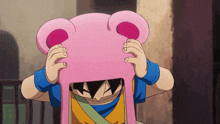 a cartoon character wearing a pink hat with ears