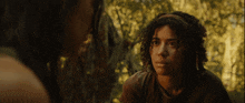 a girl with curly hair looks at another girl