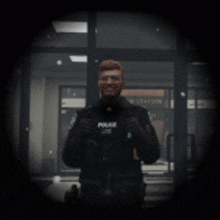 a police officer stands in front of a station