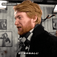 a man with a beard is wearing a suit and tie and is talking .