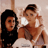 a woman adjusting her earring while another woman says maybe