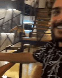 a man with a beard wearing a black shirt with a skeleton design on it